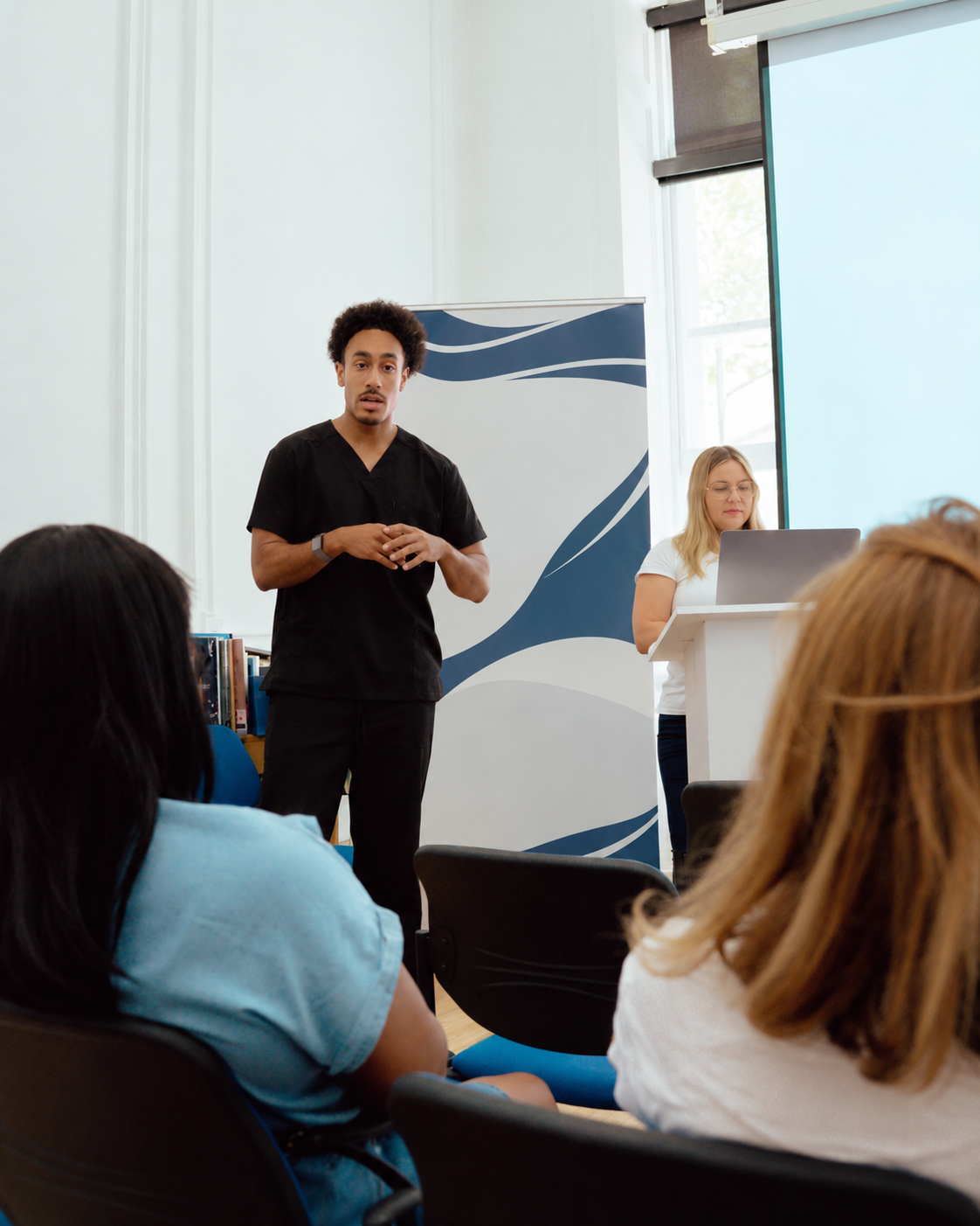 Wesley speaking to a seated group at a health workshop